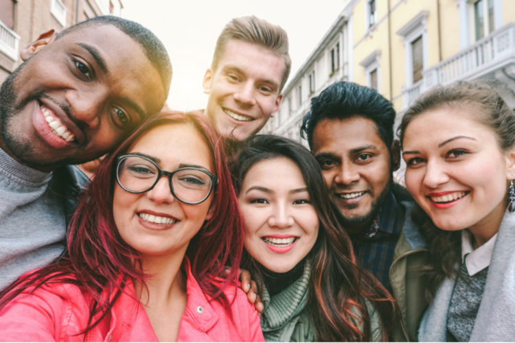 A group of six diverse adults crowds together to take a "selfie".  Gift of Life was founded to help address the lack of registry diversity, and remains committed to diversifying the pool of stem cell and bone marrow donors so that every patient in need can find a match.