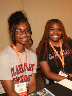 Two Gift of Life Campus Ambassadors for Fall 2023 post in their Clark University tee shirts. Both are young Black ladies who have gorgeous smiles and look excited to be part of the program. 